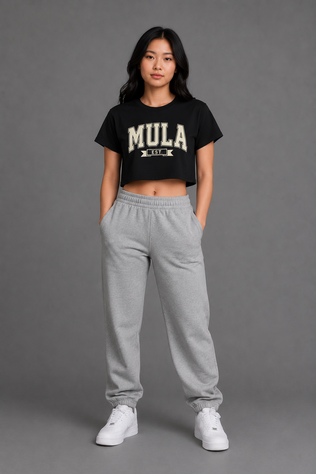 Model wearing the MULA Varsity Crop Top in black, front view