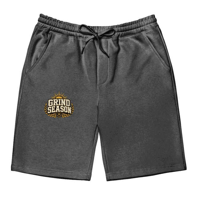GRIND SEASON stacked gold and cream emblem printed on the front right leg of black fleece shorts