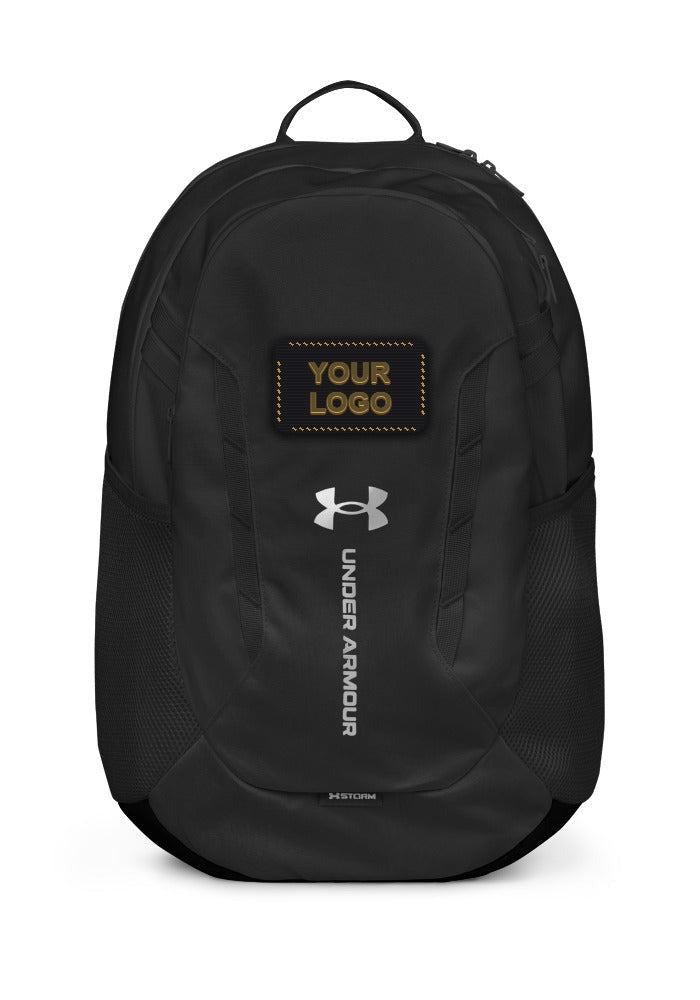 Black Under Armour Hustle backpack with YOUR LOGO embroidered patch placement above the UA logo